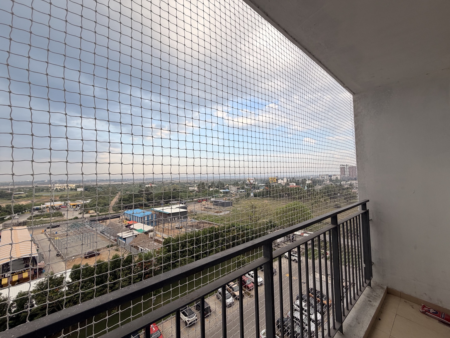 White netting fitted across an apartment balcony opening